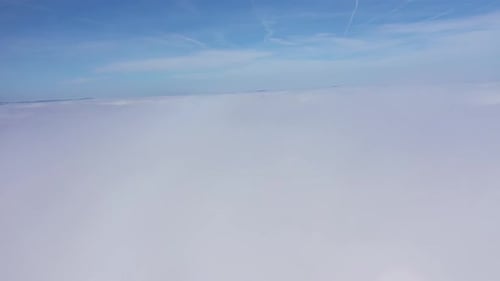 Aerial View of Above the Clouds in a Sunny Day