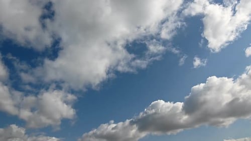 Fast-Moving White Clouds On A Blue Sky