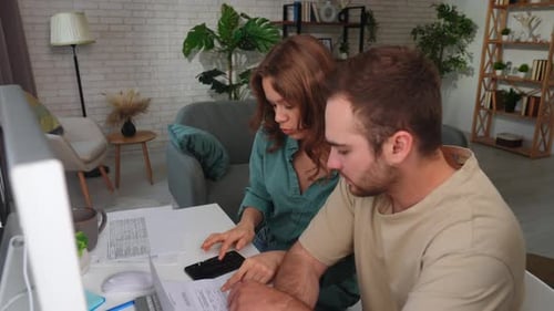 Young Professionals Collaborating on a Project in Modern Office