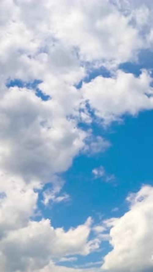 White cotton clouds soaring in the blue sky. Little clouds gathering into a big cloudscape.