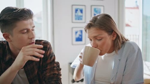 Young Adults Talking and Laughing at Table Indoors
