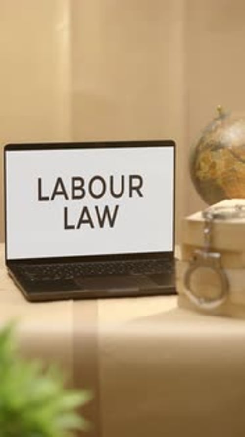 Laptop Displays Labour Law on Screen