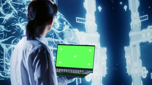 AI Script Coding on Green Screen Laptop