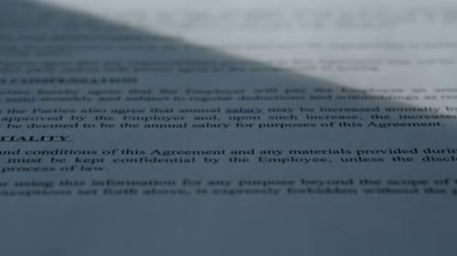 Closeup Paper Contract Text Under Sun Rays in Office Table Business Document