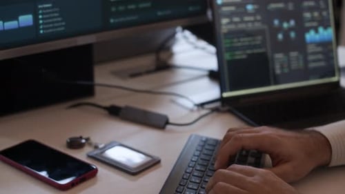 Network Administrator Programming Code on Computer in Office