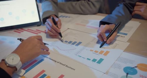 Team Reviewing Financial Reports in Workplace