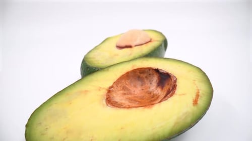 Cut avocado macro on white background isolated 4K