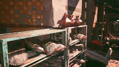 Colorful Clay Pots and Decorative Pillows Displayed in a Market Setting