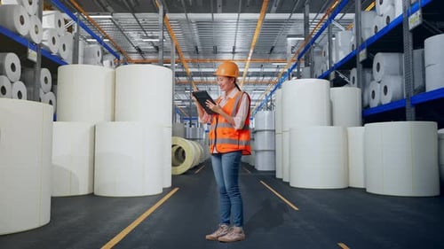 Full Body Side View Of Asian Female Engineer Taking Note On The Tablet at Polymer Plant
