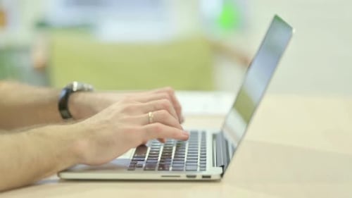 Close up of Man Typing on Laptop
