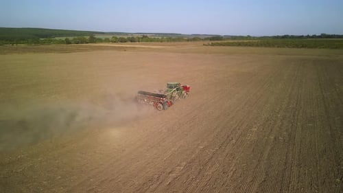 Tractor on the field seeding wheat