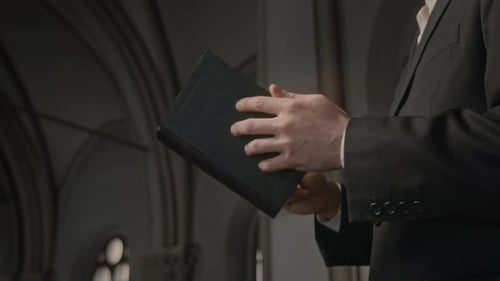 Priest Hands Holding Bible