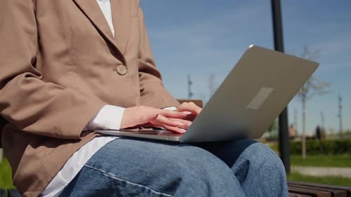 A Person is Using a Laptop Pc Computer Outdoors Under the Sun Appreciating the Fresh Air and Nature