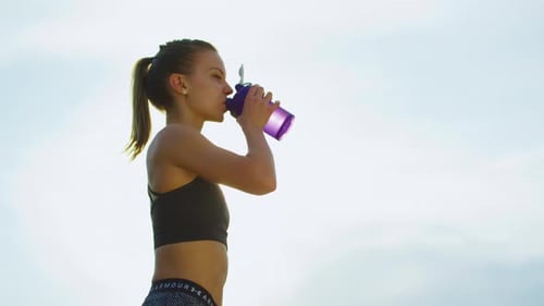 Woman Hydrating During Workout
