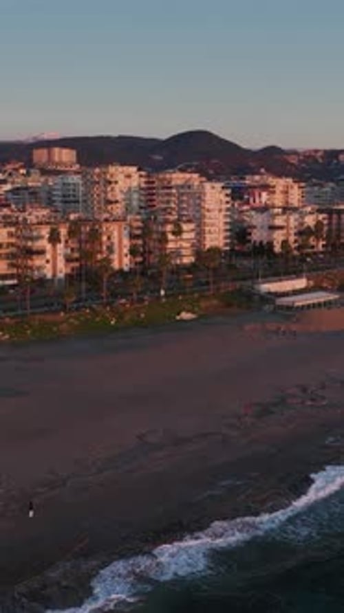 Vertical Video Golden Light of a Sunset Reflecting Beautifully on the Surface of the Ocean Waves