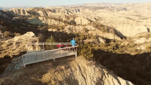 Couple With Bicycles Enjoying Mountain View From Platform