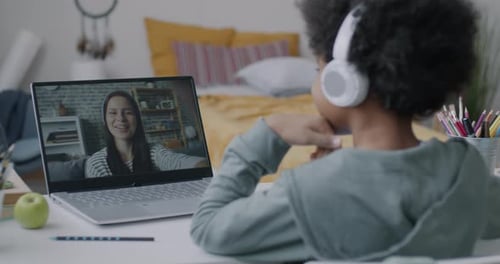 Child Video Calling with Laptop in Bedroom