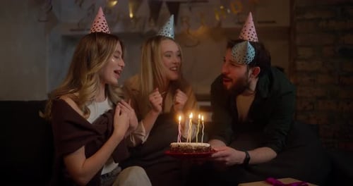 Friends Celebrate Birthday with Cake and Candles
