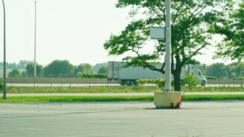 Semi-Truck Driving on Highway on a Sunny Day