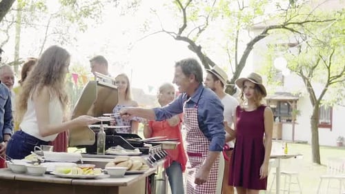 Group of Friends Enjoying Backyard Barbecue on Sunny Day