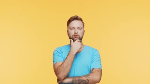 Thinking Young Man Over Vibrant Background Studio Portrait of Expressive Handsome Person