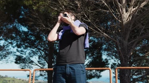 Boy In The Park Taking Photos With His Vintage Camera