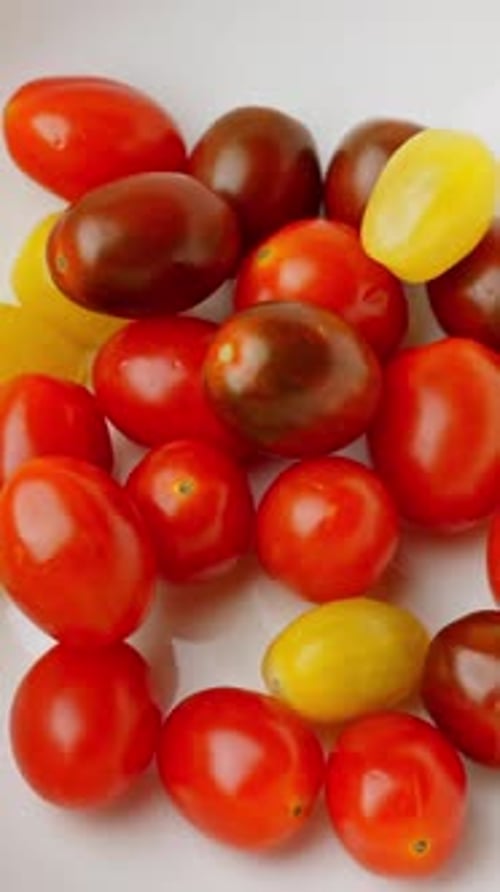 Red and Yellow Chery Tomatoes on Table Rotating shot Vertical