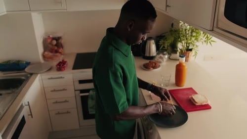 Man Makes Sandwich in a Modern Kitchen