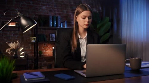 Business Woman Working on Laptop at Night
