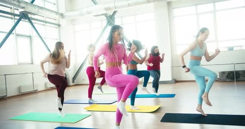 Active Women Run in Place at Fitness Training Session