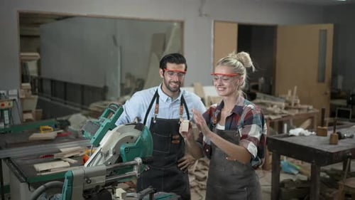 Carpenters are working together at workshop.