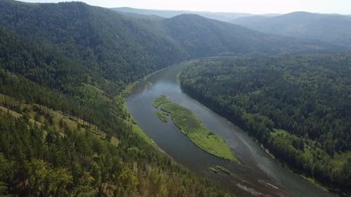 Awesome aerial view of scenic river among evergreen woods
