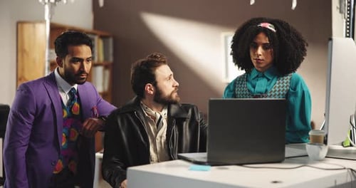 Team Discusses Computer at the Office