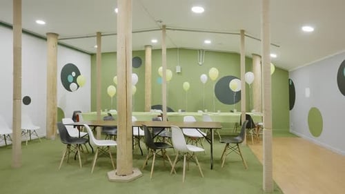 Modern Collaborative Workspace with Green Accents and Abundant Natural Light for Uplifting Energy