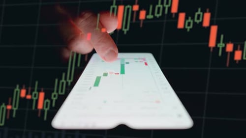 Man examining candlestick chart on a smartphone. Candlestick chart overlay