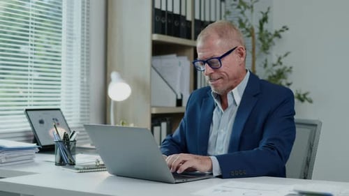 Businessman are calculating and working typing on laptop about business financial and marketing.