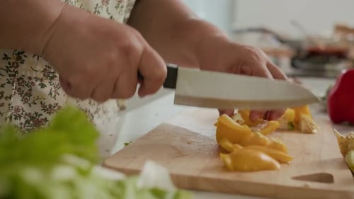 Cutting Yellow Pepper in Kitchen