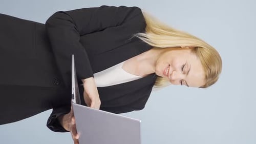 Blonde Woman Works on Silver Laptop Smiling