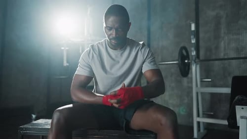 Man Wrapping Hands For Boxing in Gym