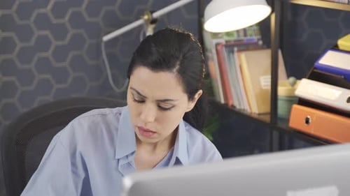 Beautiful Female Office Worker working alone.
