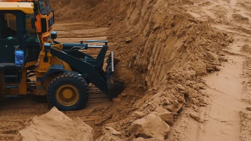 Excavator digging a quarry and loads earth into trucks. Preparing the area for construction