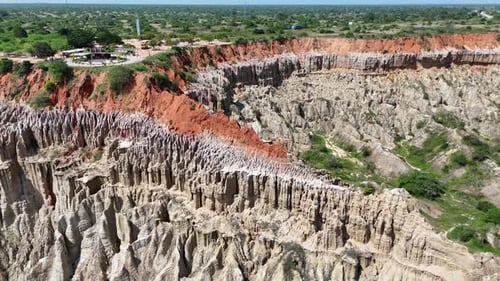 Unique Aerial View Of Red Soil Cliffs Over Grey Pinnacles