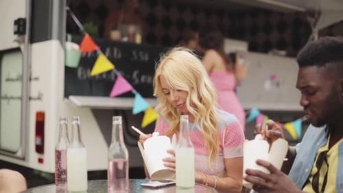 Friends Enjoying Takeout Food at Food Truck