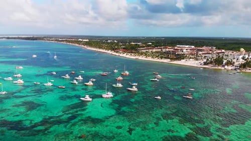 Boats and yachts in Dominican Republic, Bavaro resort in Punta Cana, Caribbean sea, aerial drone asc