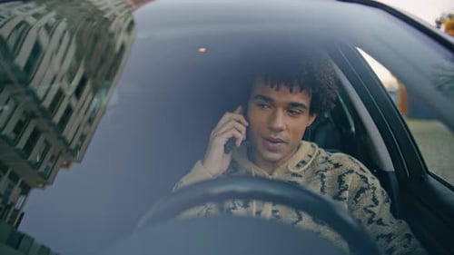 Young Adult Talking on the Phone in Car