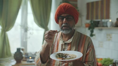 Man with Turban Presents Food on Plate