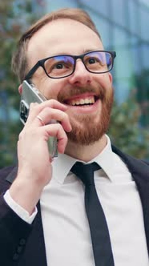 Portrait of Man Talking on Mobile Phone in City Business District Confident Young Businessman