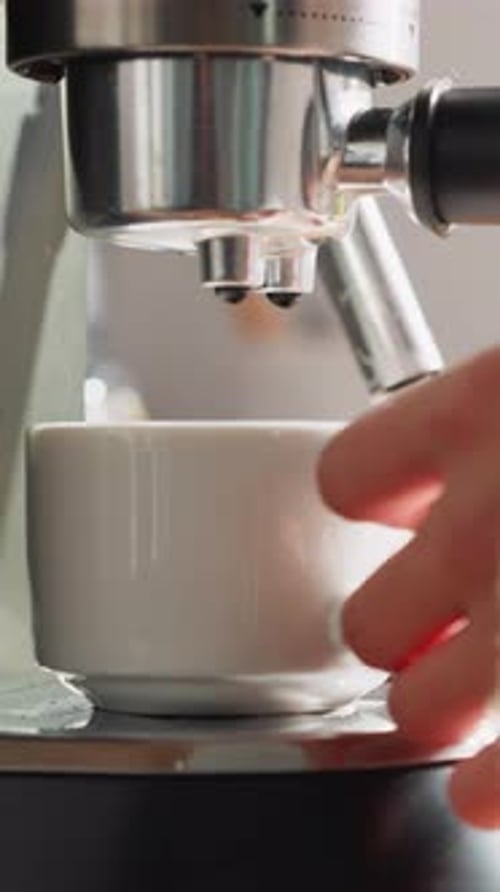 Espresso Being Dispensed from Modern Coffee Machine