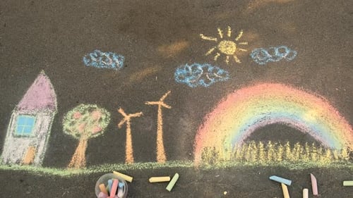 A Child Draws a Rainbow on the Pavement Selective Focus