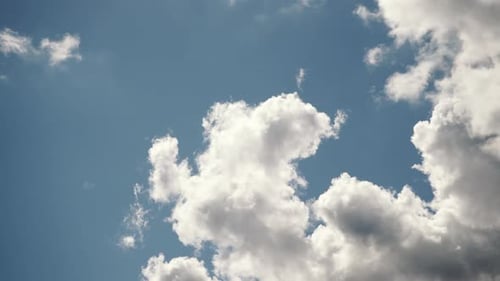Billowing White Clouds Drifting Across a Blue Sky